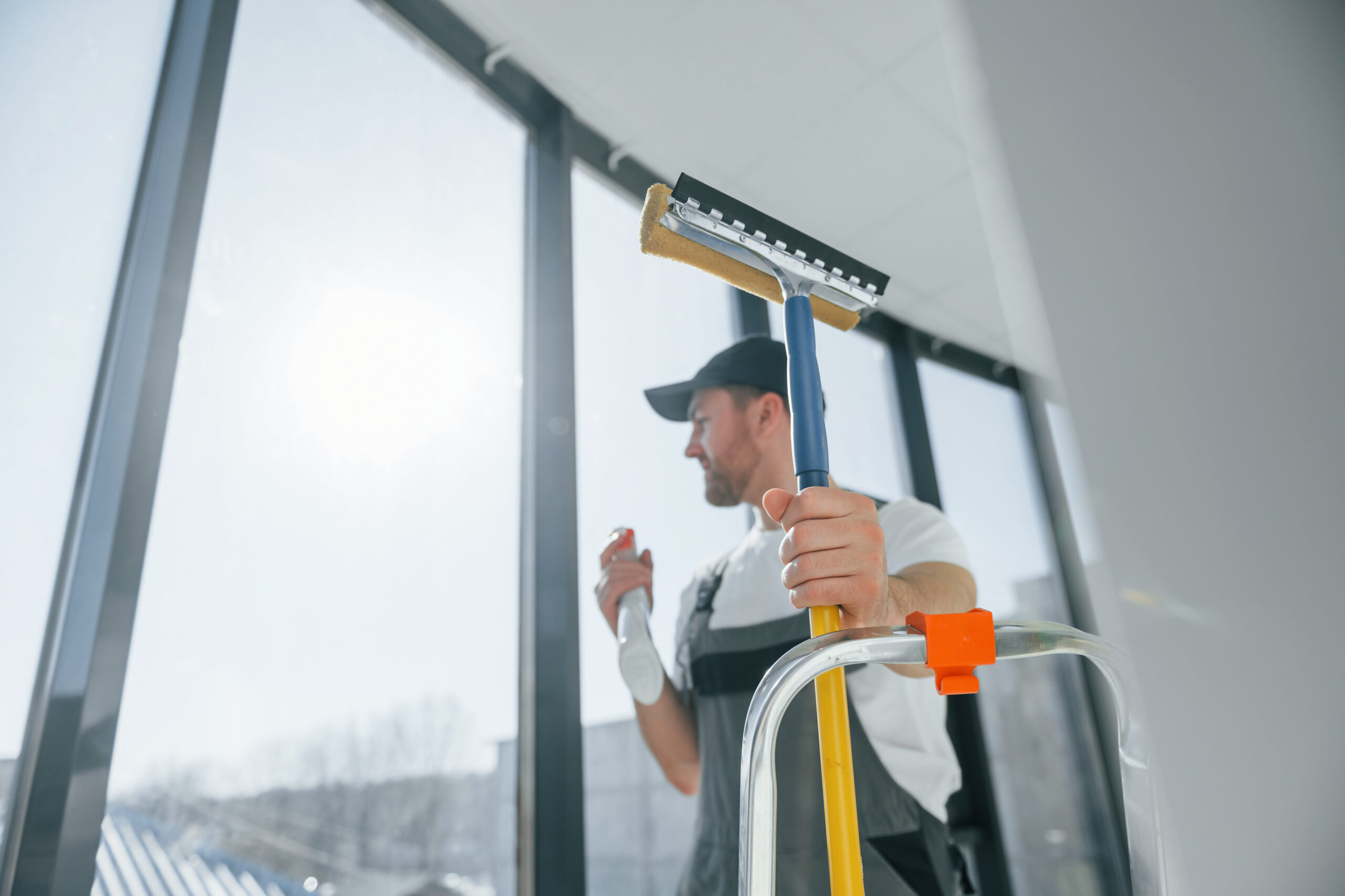 Cleaning service. Repairman is working indoors in the modern room.