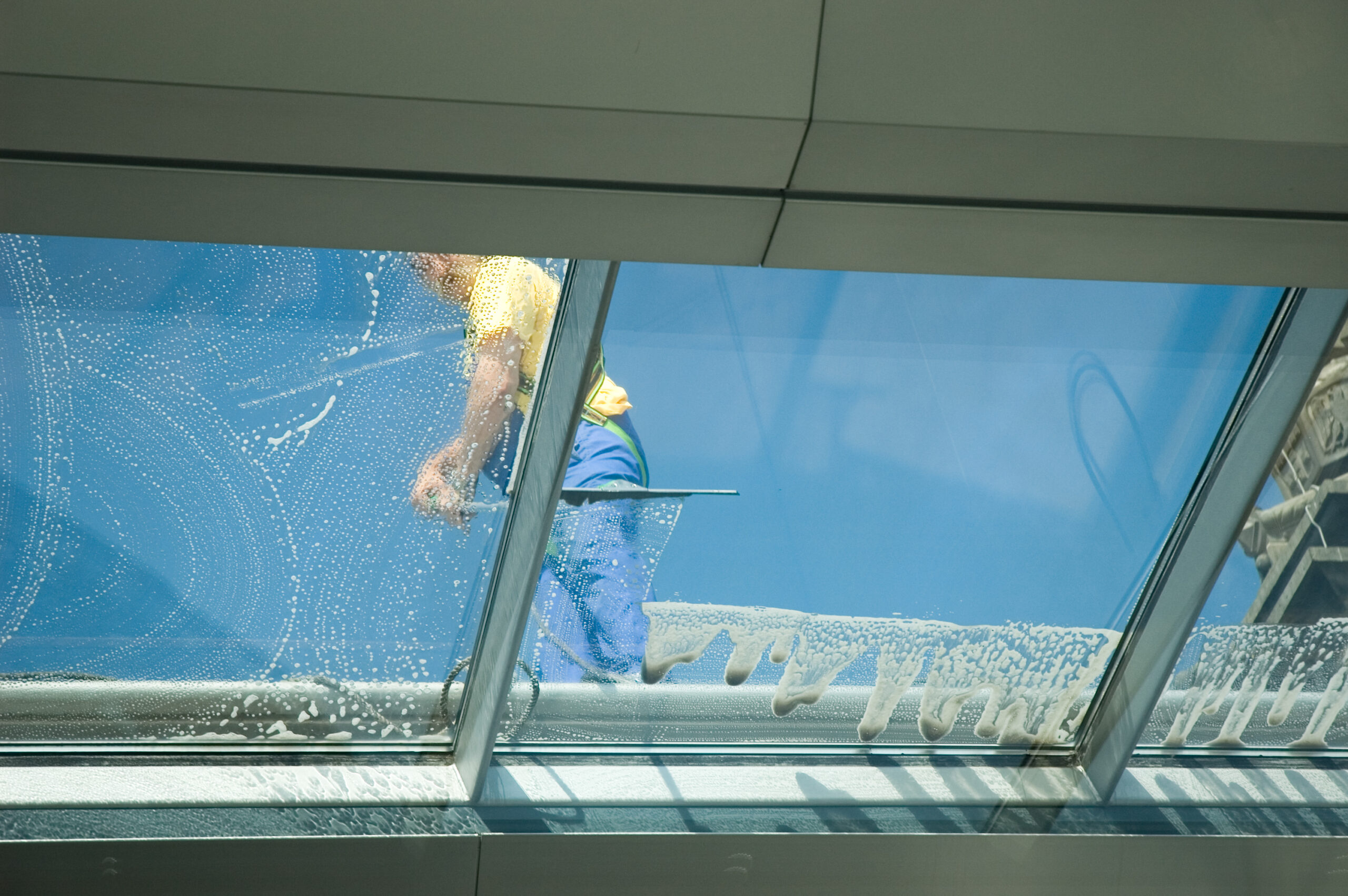 worker cleaning windows